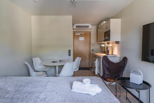 a bedroom with a bed and a table and chairs at Hotell Hanöhus Hällevik in Sölvesborg