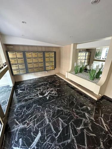 - un hall avec un sol en marbre noir et des armoires dans l'établissement Appartement « SUITE » Croisette, à Cannes