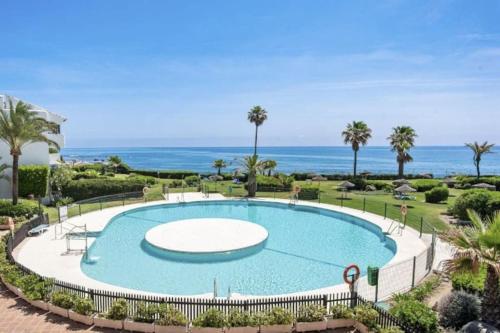 a swimming pool with the ocean in the background at Miraflores Beach & Country Club in Mijas Costa