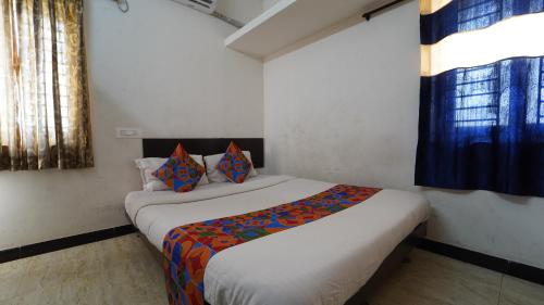 a bedroom with a bed in a room at Honey Residency Airport Codissia stay in Coimbatore
