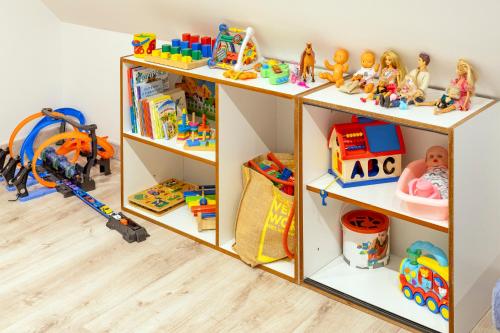 a book shelf filled with toys in a room at Chata Liptov, Domček v záhradách in Liptovská Osada