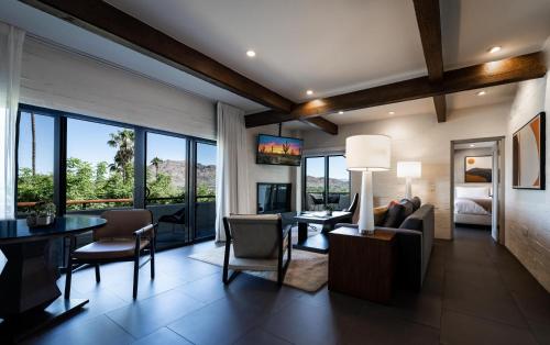 a living room with a table and chairs and a dining room at Sanctuary Camelback Mountain, A Gurney's Resort and Spa in Scottsdale