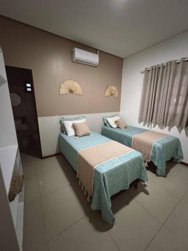 a room with two beds in a room at Casa de Praia em Lagoa do Pau Coruripe in Coruripe
