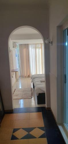 a room with a bedroom with a bed and a window at E & P HOTEL in Tetovo
