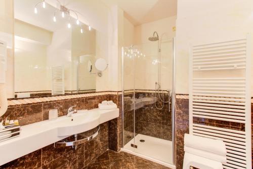 a bathroom with a sink and a shower at Monastero Resort & Spa - Garda Lake Collection in Soiano del Lago