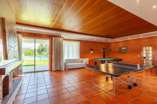 a living room with a ping pong table in it at Solar de Prado - Minho's Guest in Vila de Prado