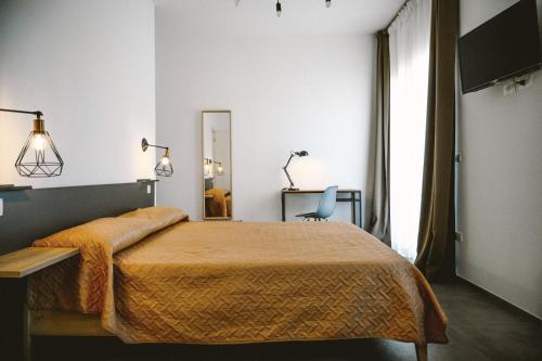 a bedroom with a bed and a chair and a mirror at Olympus in Avola