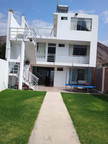 a white house with a walkway in front of it at La casa de Joselito in Pacaran