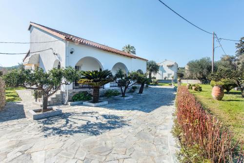 a house with trees in front of it at Villa INVA Korfu in Kavos