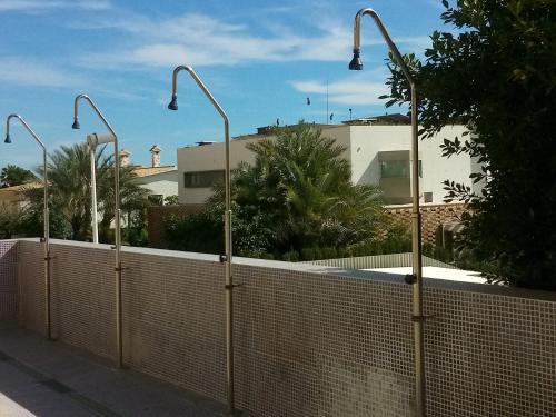 a fence with street lights on the side of a building at SEA VIEW, walking distance! Refurbished 2 bed, modern. 20 min. from Alicante Airport in Santa Pola