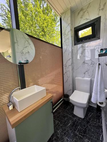 a bathroom with a sink and a toilet at Perspective Mirror House in Kocaeli