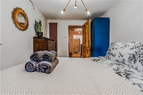 a bedroom with a bed with towels on it at Chic Victorian Basement Flat in Bristol