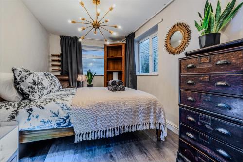 a bedroom with a bed and a dresser and a mirror at Pet-friendly flat w/ garden patio & smart tv in Bristol