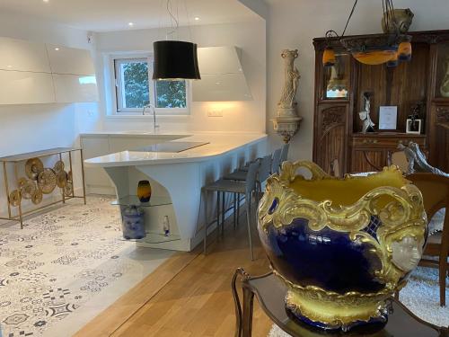 a kitchen with a counter and a table and chairs at Villa Thalassa domaineleshesperides in Bitche