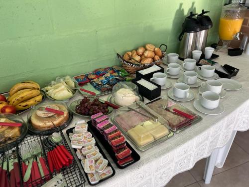 a table with a bunch of food on it at Pousada Encanto das águas in Águas de São Pedro