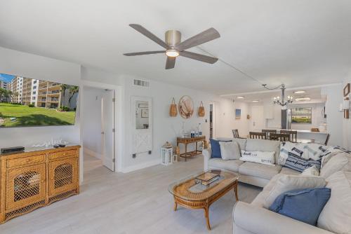 a living room with a couch and a ceiling fan at Canaveral Towers Resort-Beach, Surf, Rocket Launches in Cape Canaveral