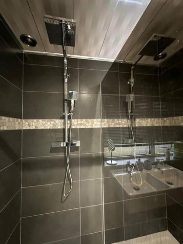 a bathroom with a shower and a sink at Charming Heywood retreat house in Heywood