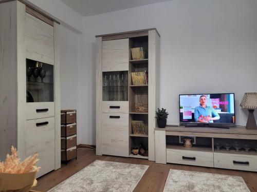 a living room with a tv on a entertainment center at Apartament Velana in Reşiţa