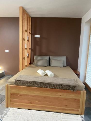 a bedroom with a bed with two towels on it at Green Valley Apartments in Zavrč