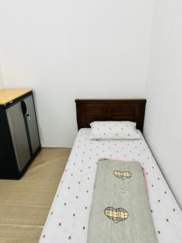 a bed in a room with a bed frame at Room for single person with sharing washroom in Sharjah