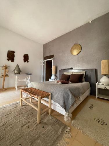 a bedroom with a large bed and a table at Villa Salvatore in Ghazoua
