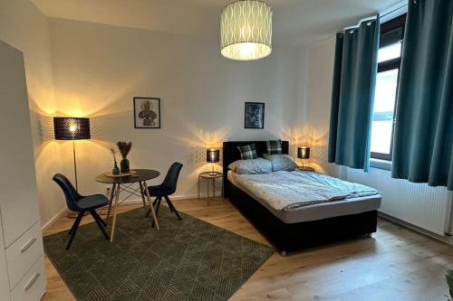 a bedroom with a bed and a table and chairs at Limburgs Herzstück in Limburg an der Lahn