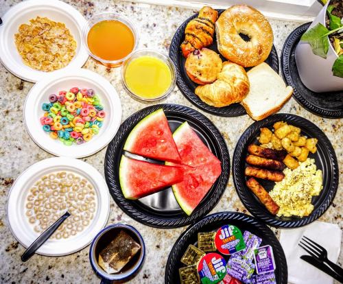 a table topped with plates of food with different foods at The Wilshire Grand Hotel in West Orange