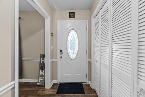 a hallway with a white door and a window at Semper Fi Serenity in Havelock