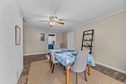 a dining room with a table and a ceiling fan at Semper Fi Serenity in Havelock