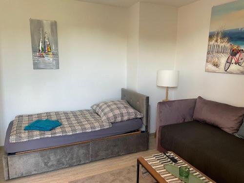 a small bedroom with a bed and a couch at 40L Luisenstr 5.OG in Castrop-Rauxel