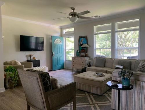 a living room with a couch and a tv at At Ease in Ocean Springs