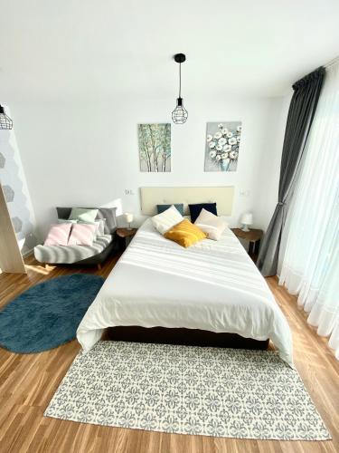 a bedroom with a large bed and a rug at Apartamentos LAMAROSA -LAS PLAYAS in Burela de Cabo