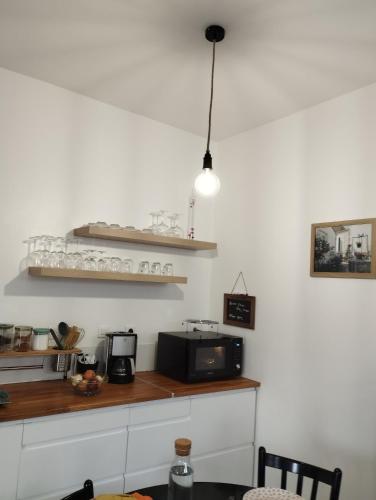 a kitchen with a counter top with a microwave at DU SEMAPHORE in Fouras