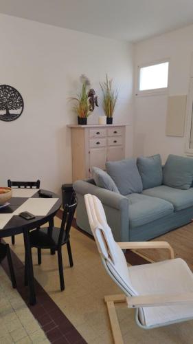 a living room with a couch and a table at DU SEMAPHORE in Fouras