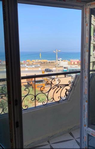 a view of a balcony with a view of the ocean at عمارة فلسطين 