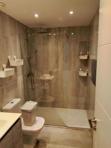 a bathroom with a shower and a toilet and a sink at Atlantic View 6B in Puerto del Carmen