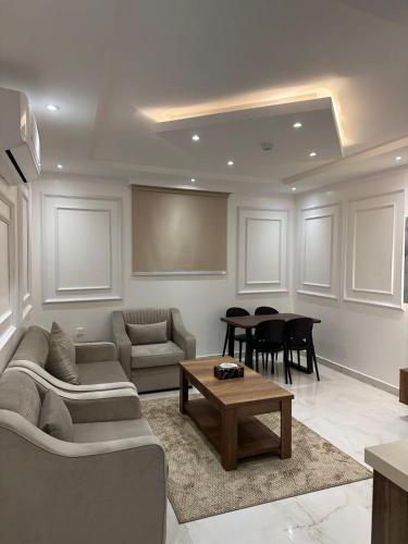 a living room with a couch and a table at ليوان الريان للشقق المخدومة Liwan Al-Rayyan for serviced apartments in Riyadh
