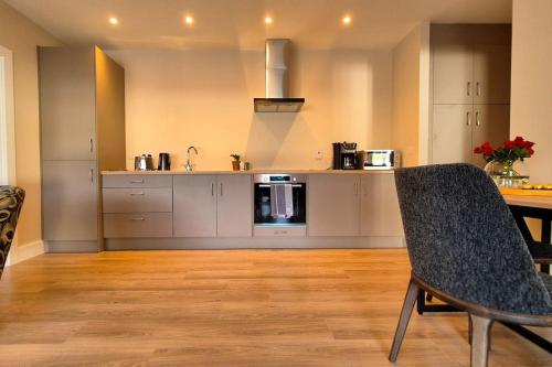 a kitchen with a table and a counter top at Modern country charm apartment. in Mullingar