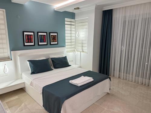 a bedroom with a bed with two towels on it at Sunshine Villa in Fethiye