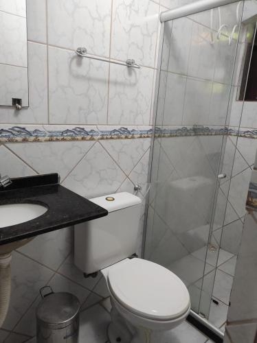 a bathroom with a toilet and a sink and a shower at Pousada Zumbi dos Palmares in Salvador