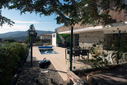 a fence with a grill in front of a house at Apartment Pearl of Cabrils in Cabrils