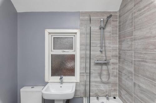 a bathroom with a shower and a toilet and a sink at Town Centre Town House free WiFi and free on street parking in Middlesbrough