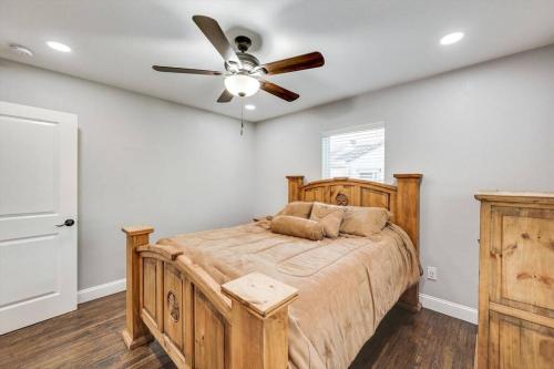 a bedroom with a bed with a ceiling fan at The Texas Experience near the Stockyards! in Fort Worth