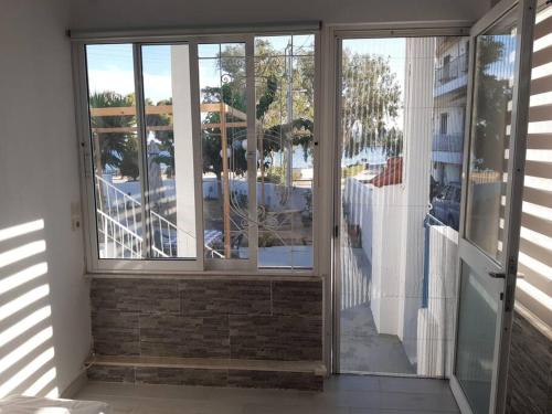 a sliding glass door to a balcony with a view at Catherine's house in Artemida