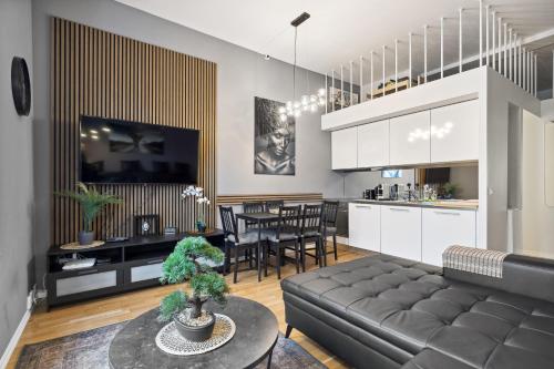 a living room and kitchen with a couch and a table at Spacious & stylish apartment in Oslo - Supercentral in Oslo