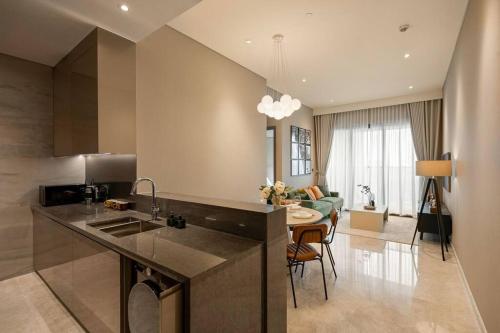 a kitchen and living room with a counter and a table at The Rixx Trendy Apartmen 2bed 1bath at The Marq in Ho Chi Minh City