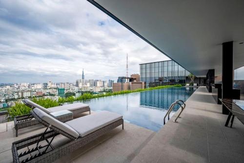 a swimming pool on the roof of a building at The Rixx Trendy Apartmen 2bed 1bath at The Marq in Ho Chi Minh City
