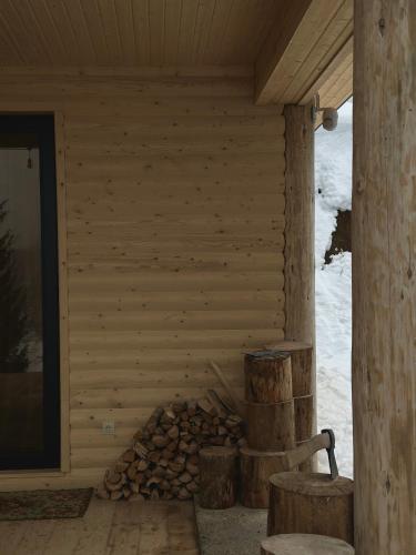 a log cabin with a fire place in the corner at In The Forest in Mestia