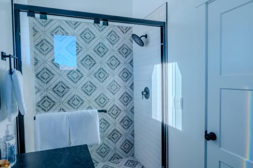 a bathroom with a shower with a glass door at Brycegate Retreat. Stunning Views. Modern Comforts. in Hatch