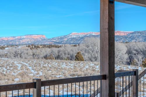 a view from a porch of a snow covered field with mountains at Brycegate Retreat. Stunning Views. Modern Comforts. in Hatch